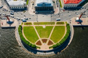 Aerial capture of a lush park surrounded by roads and waterways.